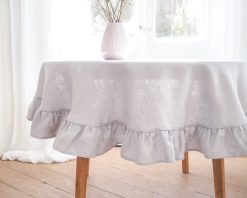 Light gray round ruffled linen tablecloth