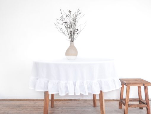 Plain linen round tablecloth with a frill
