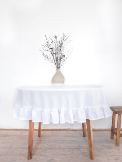 Plain linen round tablecloth with a frill