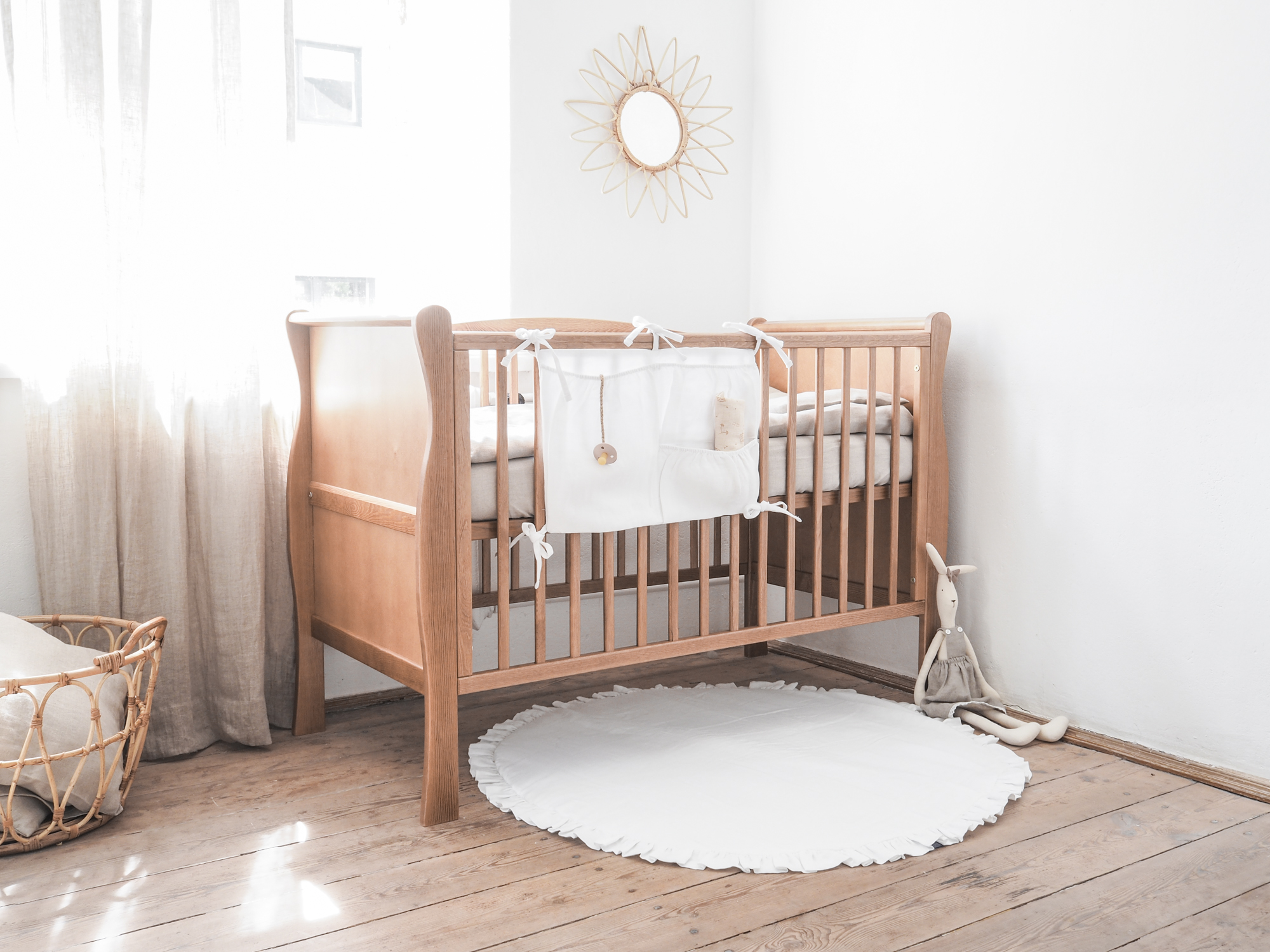 A white mat with a frill for a baby